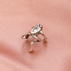 A playful froggy ear cuff made from silver-plated copper. 0.51" W x 0.35" diameter Silver-plated copper Funny Earrings, Simple Accessories, Ear Clips, Girls Earrings, Minimalist Earrings, Jewelry Party, Ear Piercings, Ear Cuff, Silver Plate