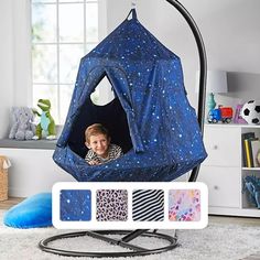 a child is sitting in a blue tent