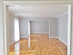 an empty living room with hard wood flooring and white trim on the walls is shown