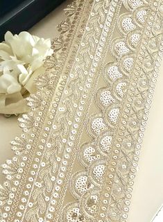 15cm Wide Golden Broad Sequence Embroidered Trim - Traditional Gothic Inspired Lace Enhance your creations with our 15cm Wide Golden Broad Sequence Embroidered Trim! This stunning cutwork trim features intricate sequence embroidery, perfect for adding a touch of traditional elegance to saris, lehengas, and various decorative projects. Materials: High-quality lace with golden thread and sequins Durable and lightweight for easy application Features: Bold design that captures the essence of gothic-inspired aesthetics Sold by the yard for versatile crafting options Easy to sew and customize for your unique style Uses: Ideal for sari borders, lehenga embellishments, and costume details Perfect for bridal wear, festive outfits, and special occasions Great for DIY projects, home décor, and decora Gold Embroidered Wedding Dress For Reception, Gold Wedding Dress With Dupatta For Reception, Elegant Gold Wedding Dress For Festive Occasions, Beige Embellished Wedding Dupatta, Elegant Gold Dupatta With Sequins, Elegant Gold Sequined Dupatta, Fitted Gold Wedding Dress For Festive Occasion, Wedding Dupatta With Sequins, Elegant Wedding Dupatta With Lace Trim