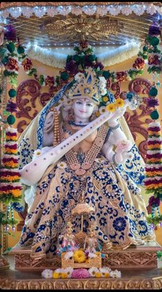 an idol is displayed in front of a wall