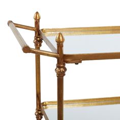 a gold metal and glass serving cart