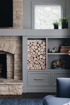 there is a fireplace with logs in it