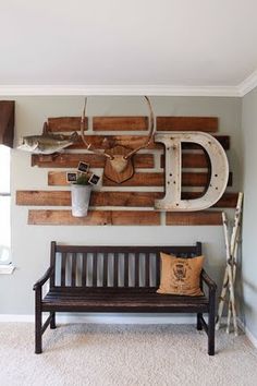 a wooden bench sitting in front of a wall mounted deer head