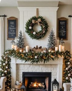 a living room decorated for christmas with candles and wreaths on the fireplace mantel