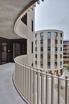 a spiral staircase in the middle of a building with balconies on each side