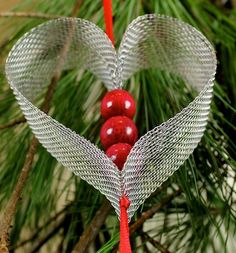 a heart shaped ornament hanging from a tree