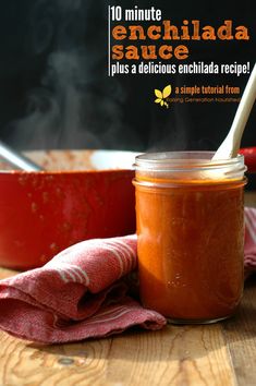 a jar filled with sauce sitting on top of a wooden table