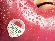 an apple with water drops on it and a sticker that says juicy tart'n thru