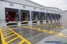 an empty parking garage with yellow and blue lines on the floor in front of it