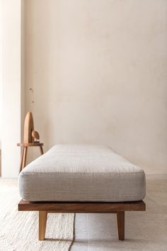 a bed sitting on top of a wooden frame