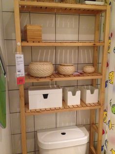 the shelves are filled with baskets and containers for storing toilet paper, books, and other items