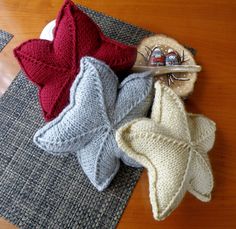 three knitted items are sitting on a table