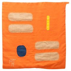 an orange wall hanging with blue and yellow circles