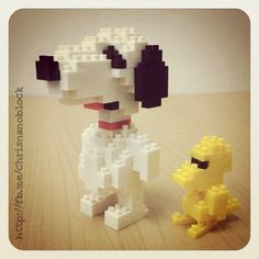 a lego dog standing next to a toy duck