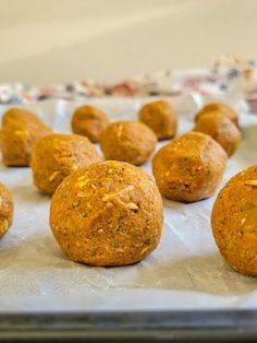 several balls of food sitting on top of a baking sheet