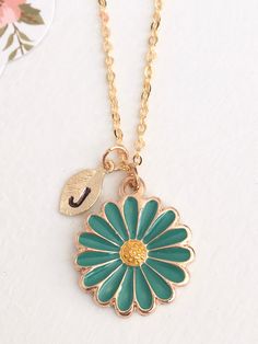 "Teal Flower Necklace, Gold Flower, Initial Flower Necklace, Anniversary Gift, Personalized Bridesmaid gift, Initial Necklace This dainty Teal Flower Necklace is plated in gold and enameled in Teal and Yellow. Personalized with tiny 16kt Gold plated leaf charm that is hand stamped with the initial of your choice. 18\" 16k Gold Plated Chain. ♥ Arrives in a gift box. ♥ With the hand stamped initial, this makes a thoughtful and personal gift. Thanks so much for stopping by. Feel free to contact me Mother's Day Green Flower Jewelry, Green Flower-shaped Dainty Necklace, Green Flower Shaped Jewelry With Floral Decoration, Green Flower Necklace Gift, Green Flower Necklace For Gift, Green Flower Necklace As Gift, Green Flower-shaped Jewelry With Flower Decoration, Green Flower Charm Jewelry, Flower Initial