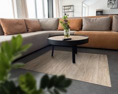 a living room filled with furniture and lots of pillows on top of a wooden table