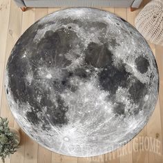 the large moon is sitting on the wooden floor