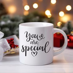 a white coffee mug with the words you are special on it next to christmas decorations