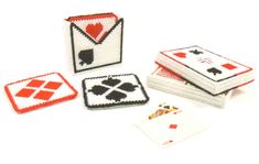 four small playing cards are shown on a white surface with red and black squares around them