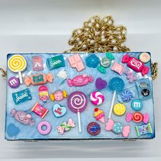 Candy Is Dandy, And This Bag Is A Snag! Made Of Hand Poured Resin And Lots Of Faux Sweets, This Bag Is Big Enough To Fit Your Cellphone And Some Treats! This Bag Has A Gold And Pearl Chain Shoulder Strap That Can Be Removed To Make A Clutch Purse Instead. Measuring 7.75" Across And 4.5" Tall, This Bag Is A Sweet Dream Final Sale - No Returns Resin Purse, Candy Purse, Chic Multicolor Beaded Bags, Multicolor Beaded Coin Purse Pouch, Leather Fringe Handbag, Cross Purses, Multicolor Beaded Rectangular Coin Purse, Fringe Crossbody Bag, Tooled Leather Purse