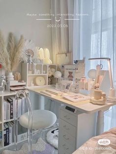 a white desk topped with lots of drawers and shelves filled with books next to a window