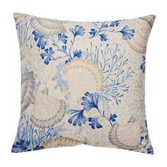 a blue and white pillow with seashells on it