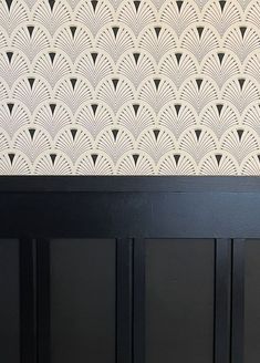 a black and white wall with art deco design on it