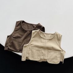 This vintage casual vest is perfect for keeping your child cozy during the spring and autumn. It is made of high-quality cotton and worsted fabric and has a comfortable O-neck design. The vest is also easy to care for, and it can be machine washed and dried. Features: Thick, warm fabric Casual style Solid color O-neck design Easy to care for Specifications: Material: Cotton, worsted Gender: Unisex Age range: Children Fit: Fits true to size Season: Spring, autumn Pattern: Solid Outerwear Type: Ve Beige Cotton Sleeveless Tank Top, Beige Sleeveless Cotton Tank Top, Cotton Tank Sweater Vest For Fall, Spring Cotton Tank Top With Pockets, Beige Sleeveless Tops With Pockets, Cotton Tank Vest For Fall, Cotton Tank Vest For Spring, Beige Cotton Vest With Pockets, Beige Cotton Vest Top