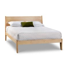 a bed with a wooden frame and green pillows on it's headboard, against a white background