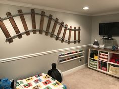 a child's playroom with toys, bookshelves and shelves in it