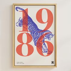 an orange and blue poster with a tiger on it's face in front of a white wall