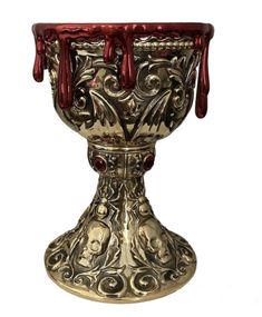 an ornate silver cup with red decorations on it