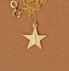 Virgin mary necklace, gold star necklace, celestial necklace, 5 point star, a 14k gold vermeil virgin Mary star on a 14k gold filled chain A delicate and dainty, 14k gold vermeil star with the virgin mary hangs on a 16 inch 14k gold filled chain. The star measures 15mm. Looking for other charm necklaces? https://www.etsy.com/shop/BubuRuby?section_id=12318467 More crystals and healers? http://www.etsy.com/shop/BubuRuby?section_id=13073583 Want to see more gems? http://www.etsy.com/shop/BubuRuby?s Virgin Mary Necklace Gold, Mary Necklace Gold, 5 Point Star, Gold Star Necklace, Mary Necklace, Virgin Mary Necklace, Star Necklace Gold, Celestial Necklace, Charm Necklaces