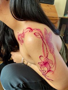 a woman with a dragon tattoo on her shoulder