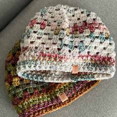 two crocheted hats sitting on top of each other