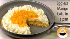 an eggless mango cake in a pan with a bite taken out of the top