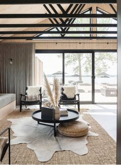 a living room filled with furniture and lots of windows