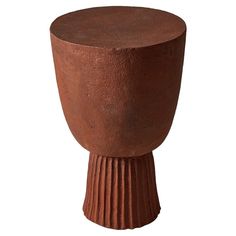 a brown vase sitting on top of a wooden table