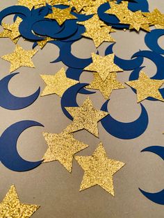 some gold stars and crescents on a table