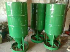 three large green barrels sitting next to each other