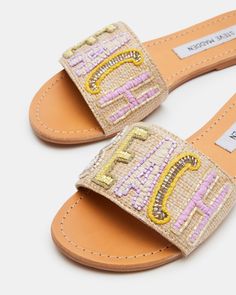 SUNNY + EASY + WHIMSICAL SEASIDE adds dynamic texture to a simple flat slide look with beaded embellishment on the wide front strap and decorative overstitching around the welt. Embellished flat slide sandal Slip-on style Beaded text design on woven strap Contrast overstitching around top of sole .25 inch heel height Textile upper material with beading Textile lining Leather sock Synthetic sole Imported Casual Embellished Flat Heel Sandals, Casual Flat Embellished Sandals, Casual Embellished Flat Sandals, Sandals Steve Madden, Embellished Flats, Beaded Sandals, Leather Socks, All About Shoes, Wholesale Shoes