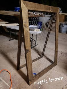 a wooden frame with chicken wire in it