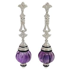 Amethyst 69.95 carats with Diamond 2.11 carats and Pearl Earrings set in 18 Karat White Gold Settings Width: 1.7 cm Length: 7.4 cm Total Weight: 33.17 grams "We first opened doors in 1980 when it was then situated in the vicinity of the Victory Monument; a small and modest storefront with a couple of counters. From its humble beginnings to where it stands today, our company has proven its abilities as a jeweler. Since the beginning, we have been supplying fine quality pieces to dealers, wholesal Luxury Formal Earrings With Gemstone Accents, Luxury Purple Earrings For Evening, Luxury Amethyst Earrings With Gemstone Accents, Luxury Amethyst Earrings For Formal Occasions, Luxury Purple Round Earrings, Luxury Silver Amethyst Earrings, Formal Amethyst Gemstone Earrings, Elegant Purple Jewelry With Polished Finish, Amethyst Earrings Fine Jewelry For Formal Occasions