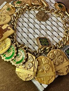 This is heavyweight vintage/antique Four H club themed charm bracelet, which is gold filled and has 20 different gold filled charms on it.  (a couple are actually sterling) The charms include ones for achievement, clothing, safety, membership, economics, etc.   This bracelet weighs 65.8 grams overall, which is over 50 dollars in SCRAP weight.  It measures 6 1/2 inches, so it should fit all ladies wrists, except oversized.  Nice antique collectible bracelet for any Four H club member or collector, or good if you collect rare charms.   Super nice piece. 50 Dollars, Vintage Charm Bracelet, Jewelry Lookbook, Antique Vintage, Necklaces Bracelets, Vintage Antiques, Gold Filled, Jewelry Bracelets, Charm Bracelet