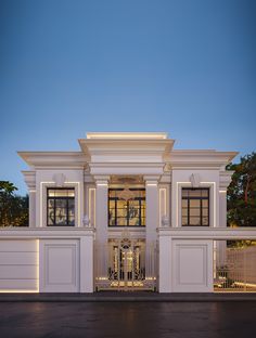 a large white building with columns on the front and side walls at night, lit up by street lights