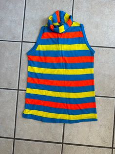 This vintage 70's turtleneck tank top is in good condition. it has  neon stripes in turquoise, yellow and orange. It is  sleeveless. It has a back zip closure. tag says size large.  I would go with the measurements which would be kids size Large or adult misses size XS chest-34 inches no pull              -38 inches with pull waist-32 inches bottom hem circumference-36 inches length-23 inches turtle not folded-3 inches To see more of our authentic 1970's vintage clothing inventory please visit o Turtleneck Tank Top, Silly Clothes, Fashion Reference, Funky Style, Neon Stripes, Funky Outfits, Sleeveless Turtleneck, 1970s Fashion, Funky Fashion