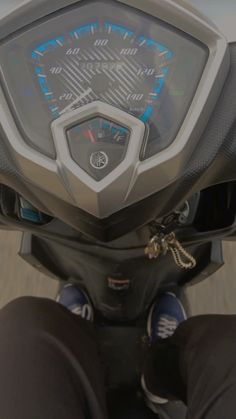 a person riding on the back of a motorcycle with blue and white numbers written on it