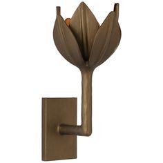 a wall mounted candle holder with a flower on it